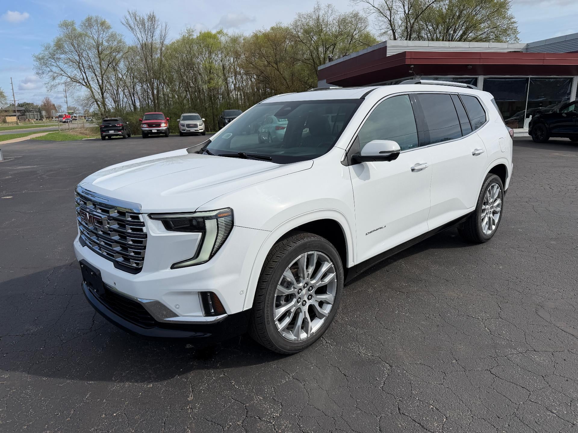 2024 GMC Acadia Denali in Summit White — front three-quarter view
