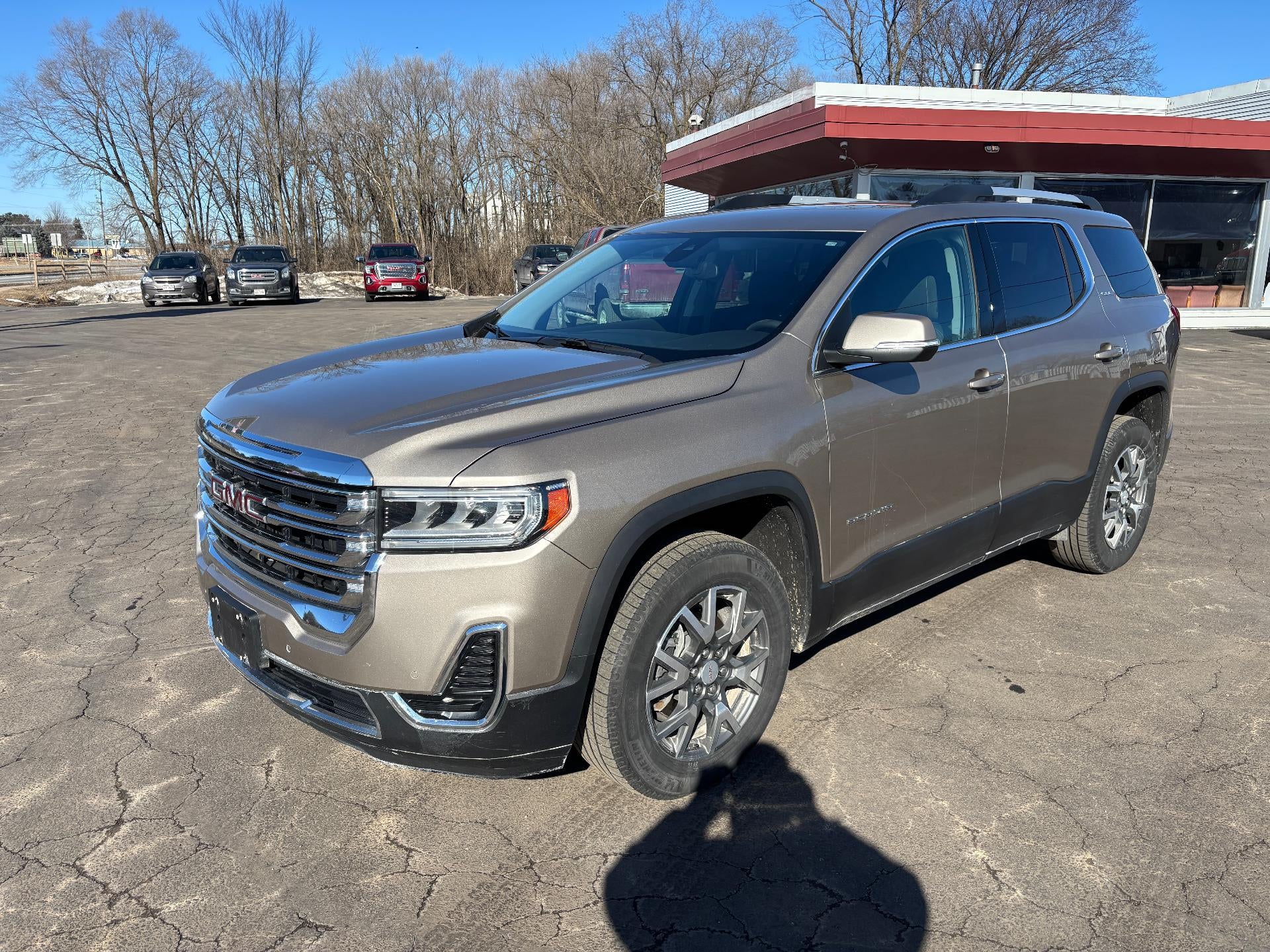 2023 GMC Acadia SLE in Light Stone Metallic — front three-quarter view